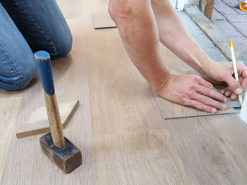 Worker installing hardwood flooring