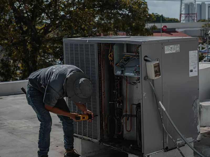HVAC technician servicing an air conditioner