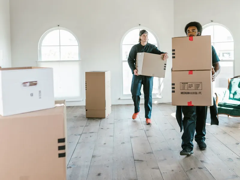 Movers carrying boxes to a truck