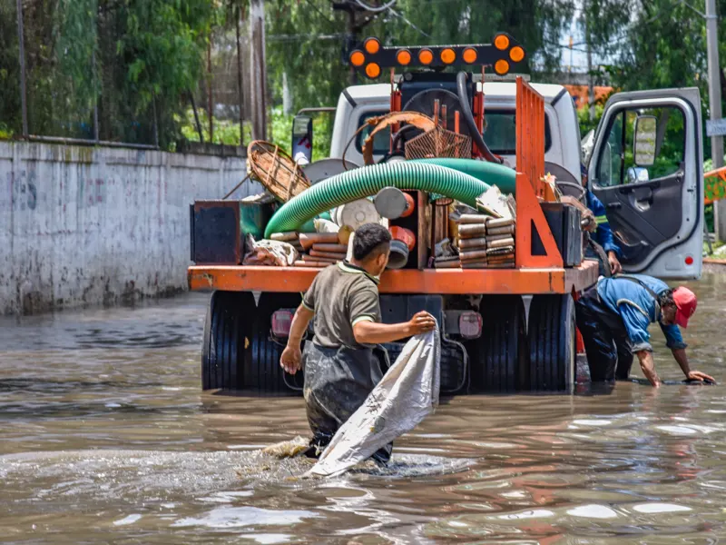 Workers cleaning up a flooded area