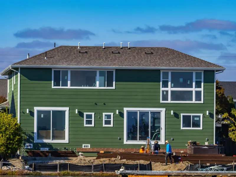 Worker installing exterior siding